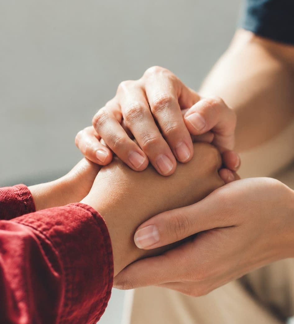 Two hands holding each other